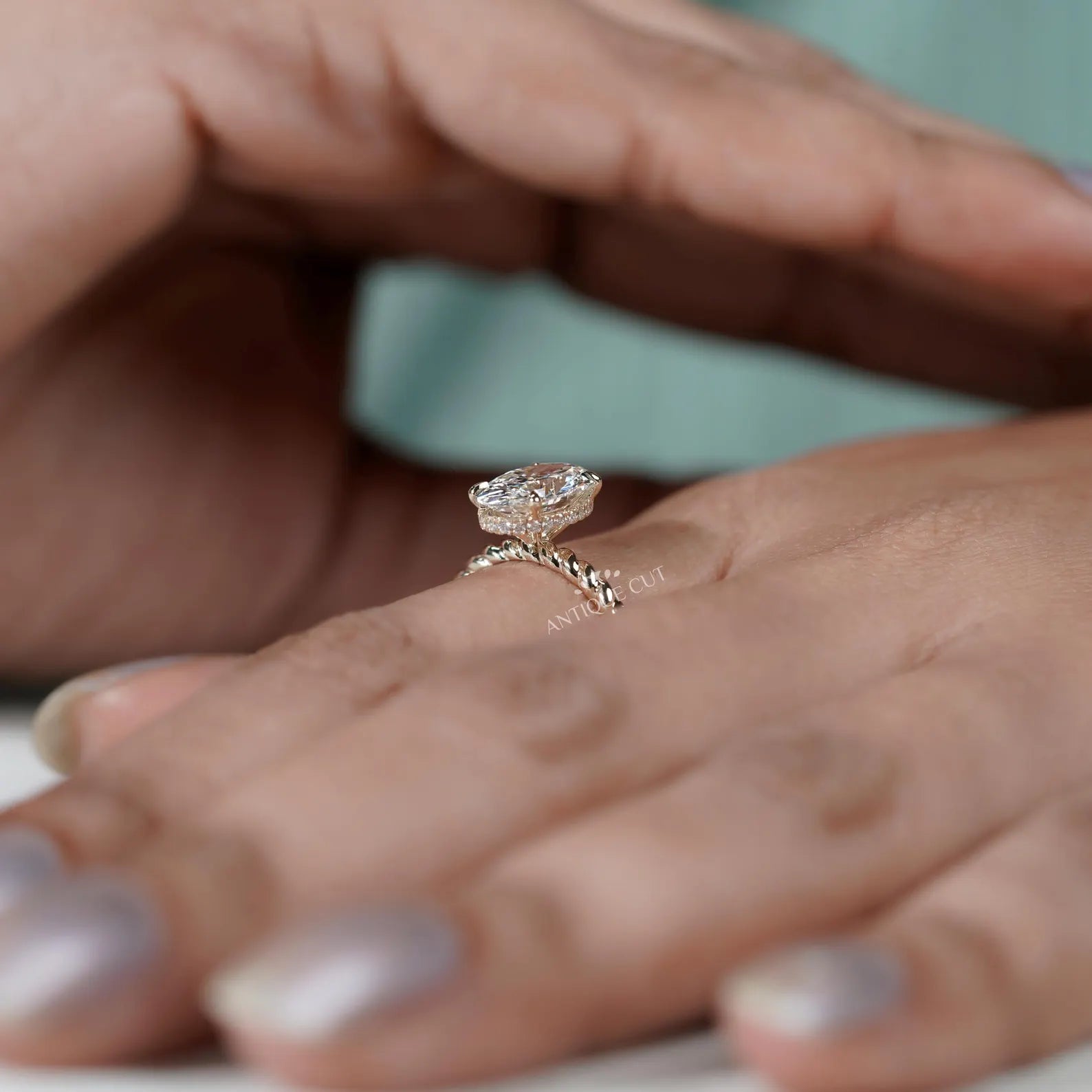 Hidden Halo Oval Cut Engagement Ring with Twisted Gold Band