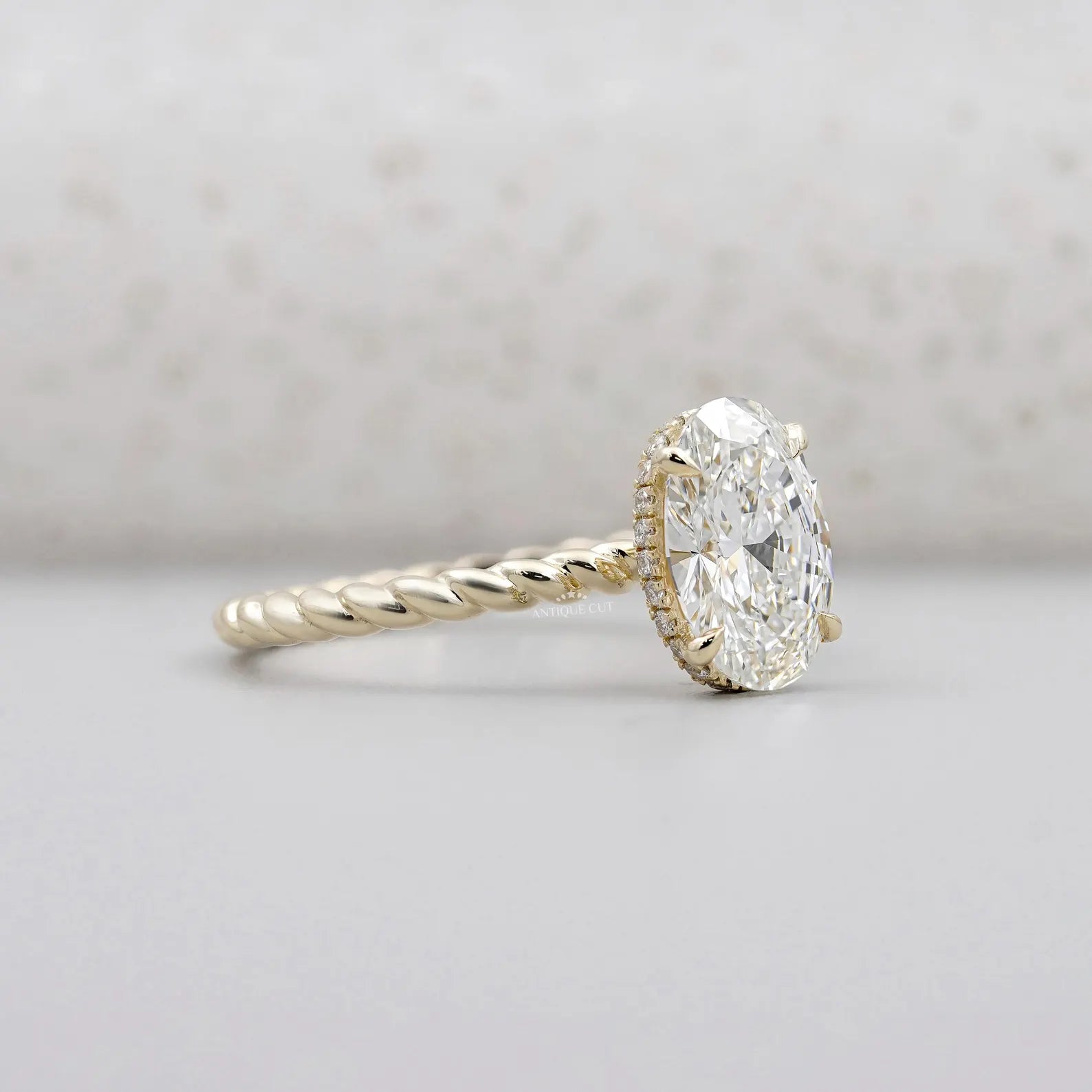 Hidden Halo Oval Cut Engagement Ring | Twisted Gold Band in Yellow Gold | IGI Certified