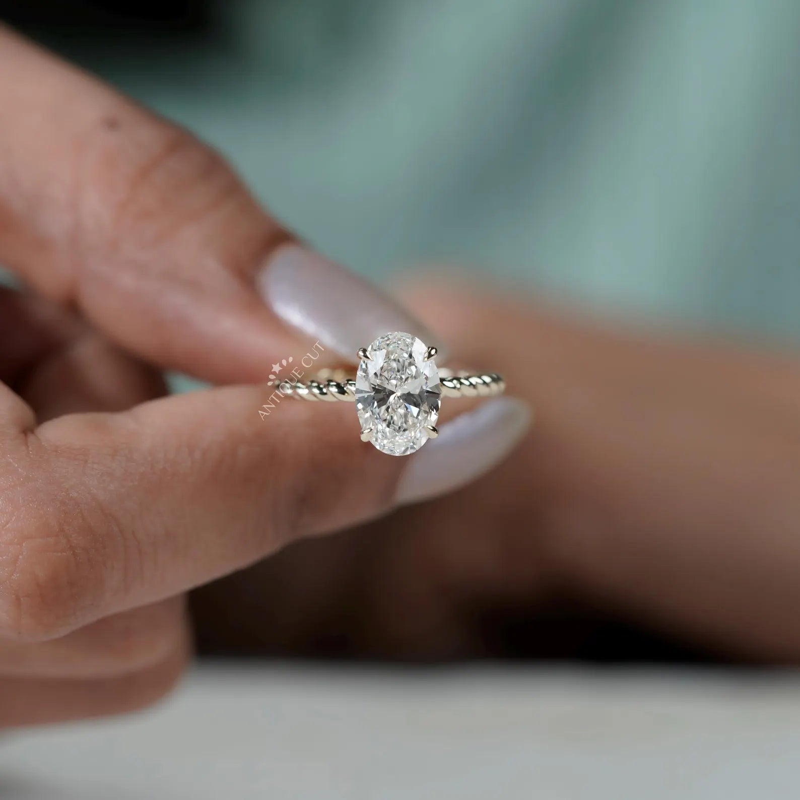 Hidden Halo Oval Cut Engagement Ring with Twisted Gold Band