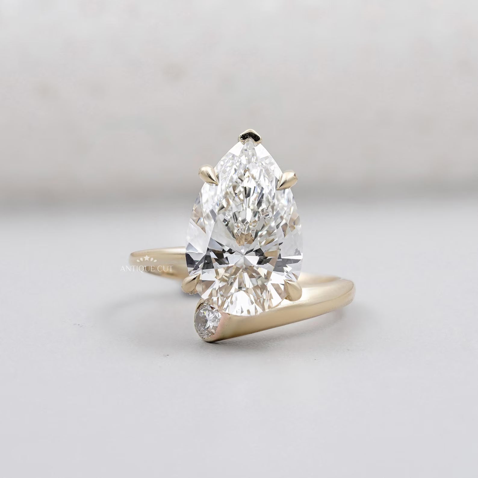 Solitaire Pear Shape Diamond Ring With Side Stone Pear In Yellow Gold
