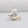 Pear shaped diamond ring with claw prong and V prong setting in yellow gold