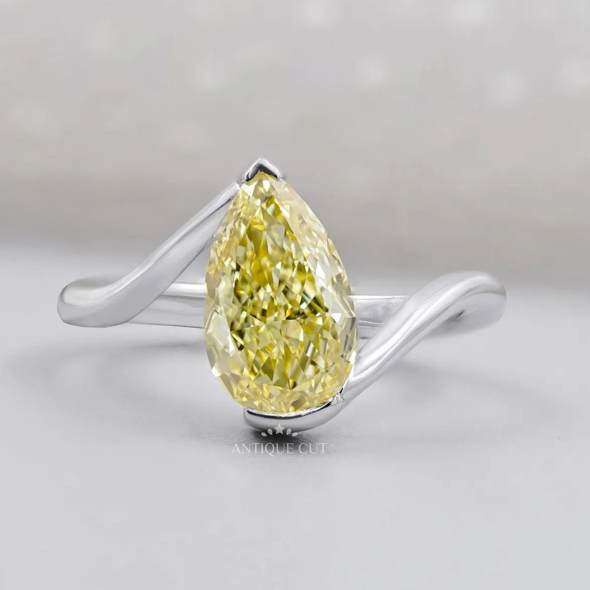 Yellow pear cut diamond wedding ring with IGI certified stone