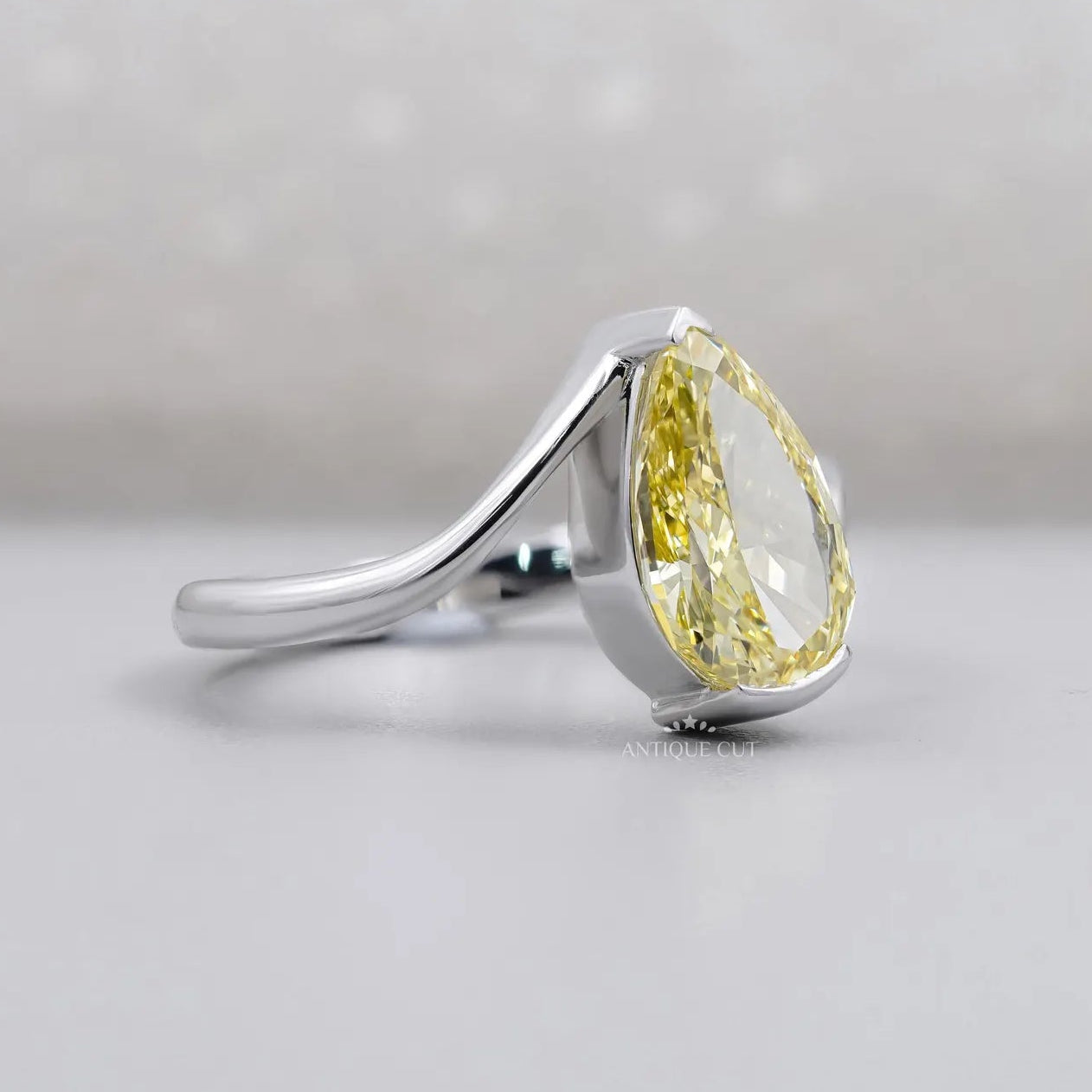 Fancy yellow pear diamond bypass engagement ring