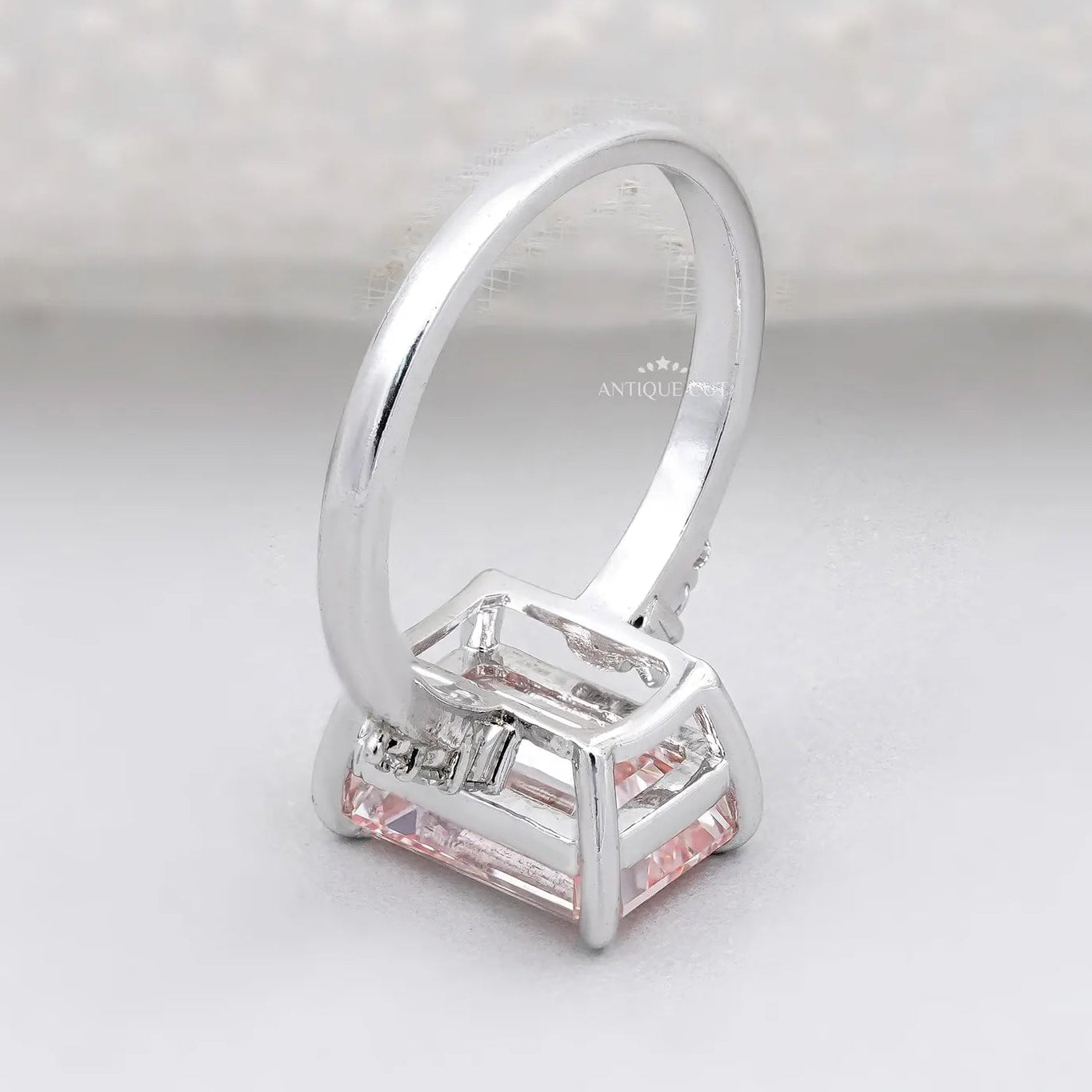 Lab grown pink diamond engagement ring with emerald cut center stone
