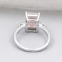 Pink solitaire diamond ring with side diamond accents