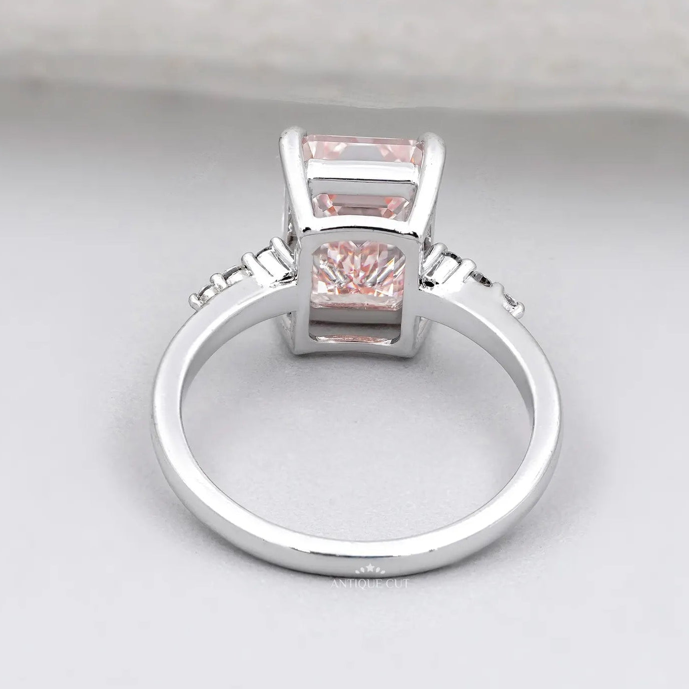 Pink solitaire diamond ring with side diamond accents