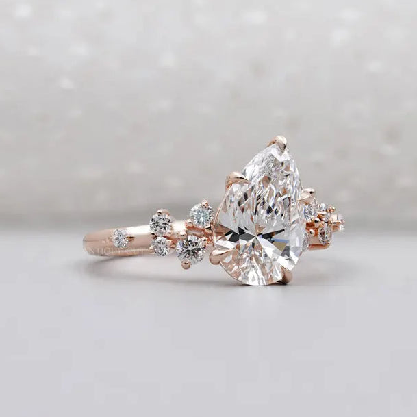 Rose gold pear engagement ring with side stones