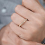 Round cut diamond band with polished yellow gold design