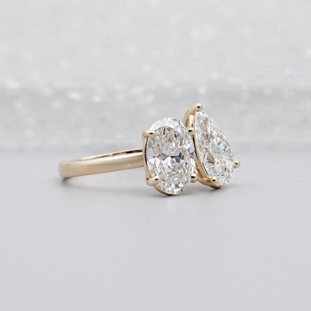 Oval and pear diamond engagement ring in gold