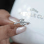 Oval engagement ring with sparkling pave band