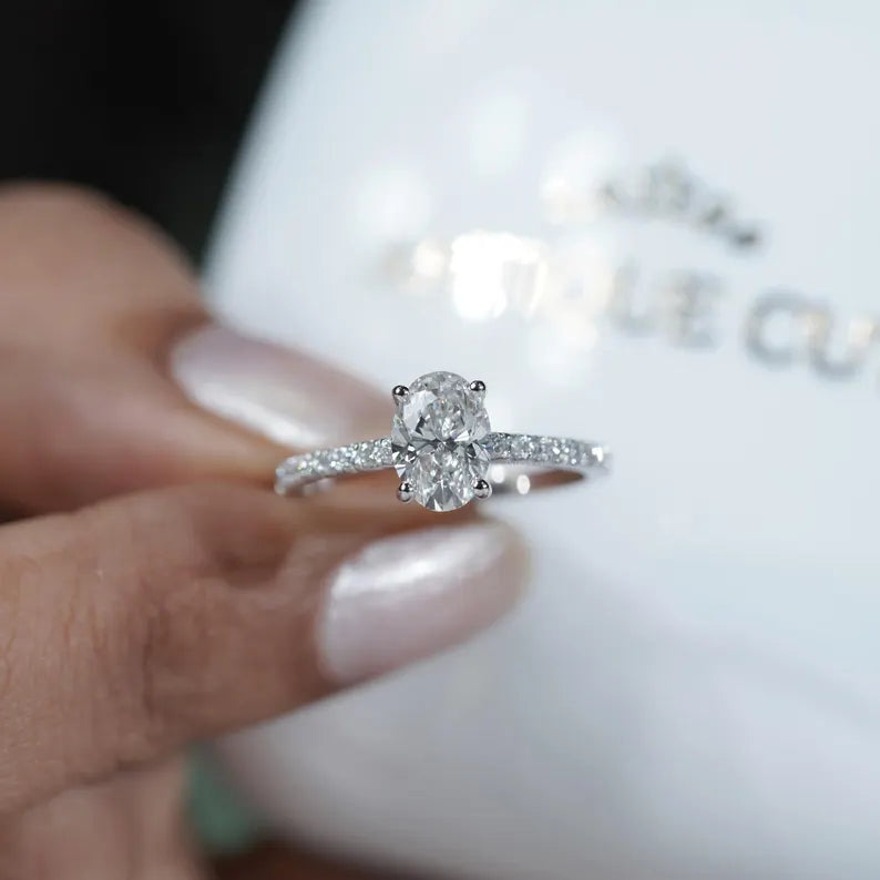 Oval engagement ring with sparkling pave band