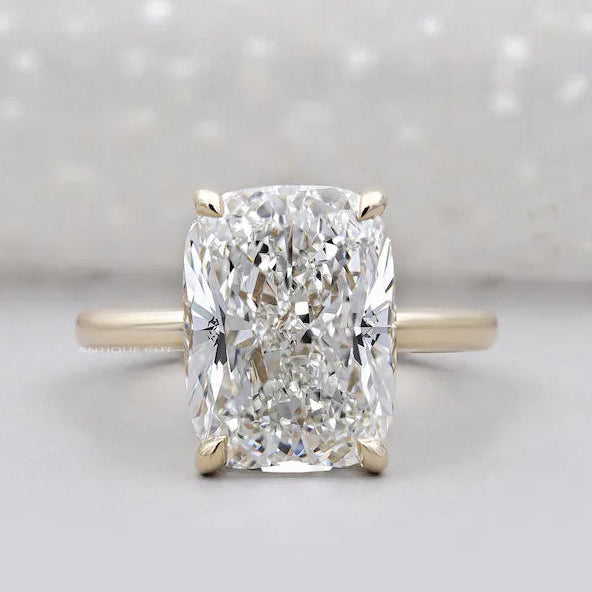 Cushion solitaire engagement ring in yellow gold