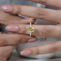 Yellow diamond ring on a hand with a blurred background
