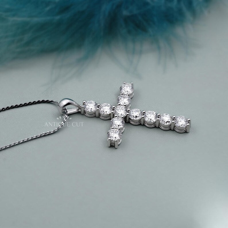 Gold cross necklace with diamonds on a person's neck

