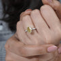 Gold ring with a diamond on a person's finger

