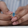 Luxury blue diamond solitaire ring hidden halo oval
