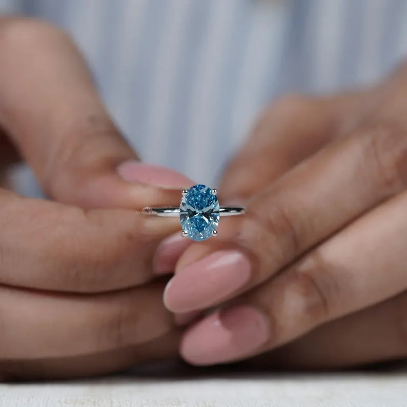 Luxury blue diamond solitaire ring hidden halo oval
