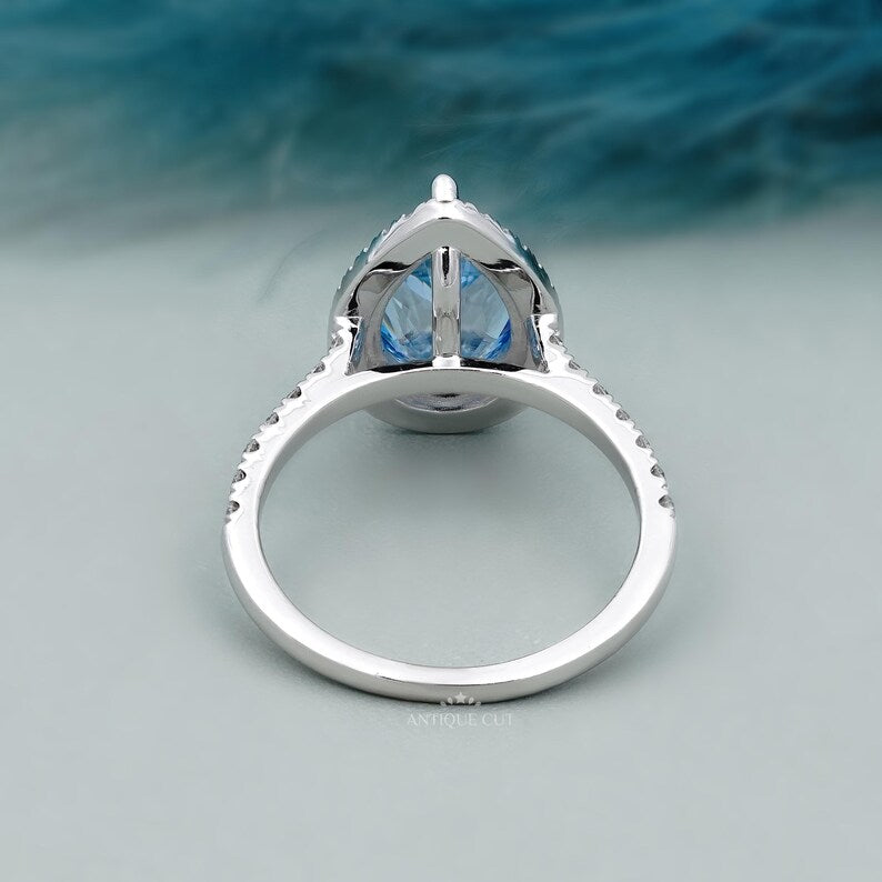 Antique cut blue pear diamond engagement ring halo
