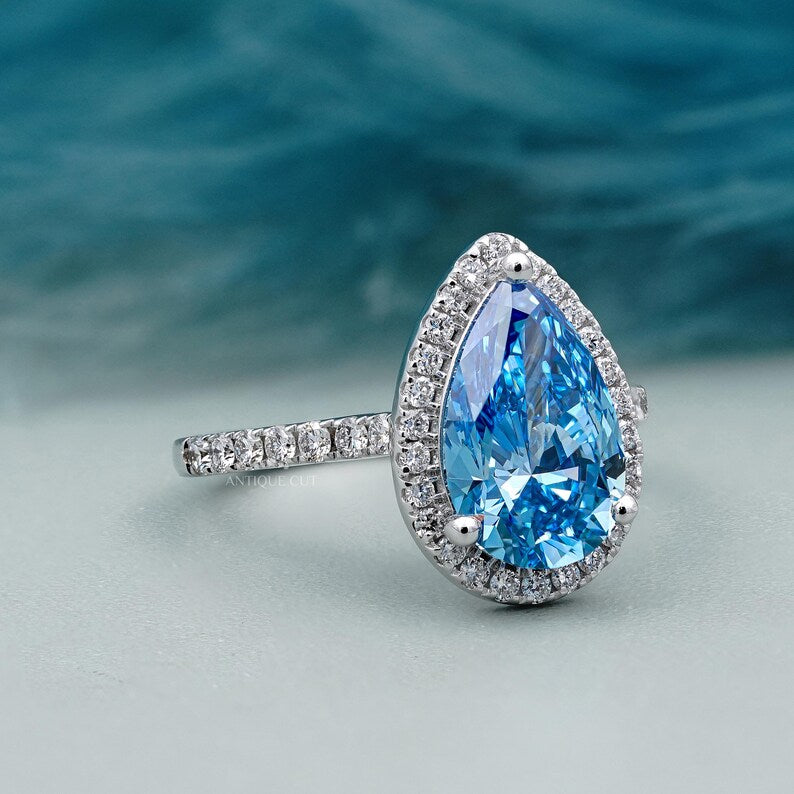 IGI certified blue diamond pear ring with pave band
