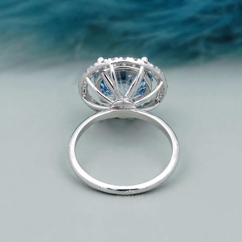 Silver ring with a blue gemstone on a light gray background

