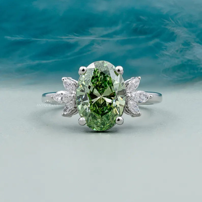 Oval green diamond ring with side stones 4 prong
