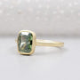 Yellow gold bezel set cushion cut diamond ring.