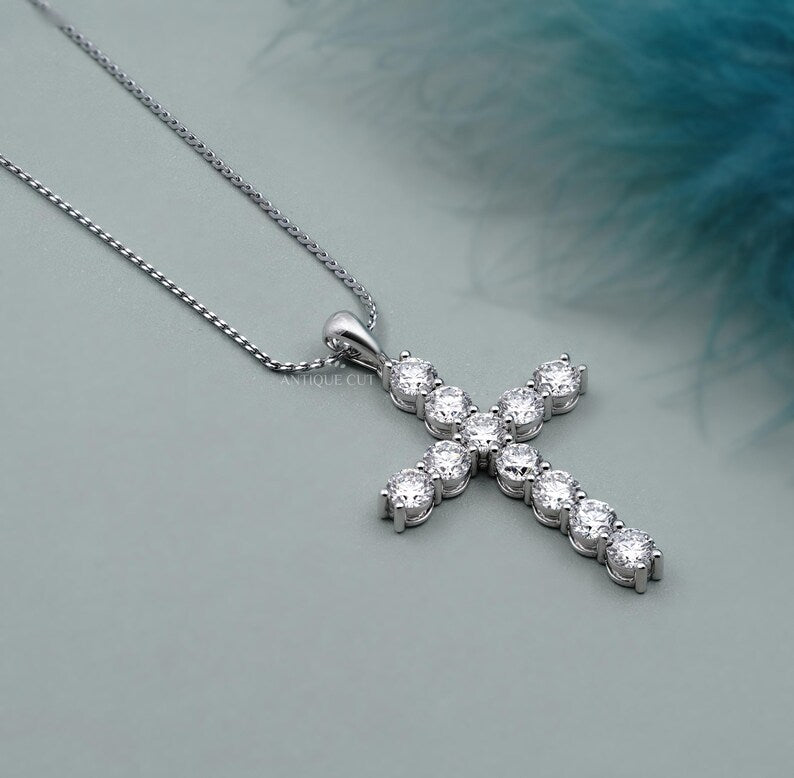 Gold cross necklace with diamonds on a person's neck

