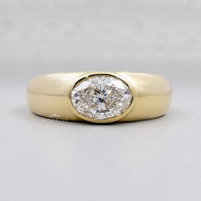 East West Oval Engagement Ring in yellow gold bezel setting