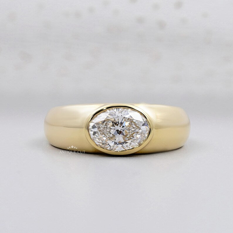 East West Oval Engagement Ring in yellow gold bezel setting