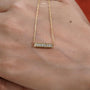 This is a beautiful bar necklace with shining diamonds.