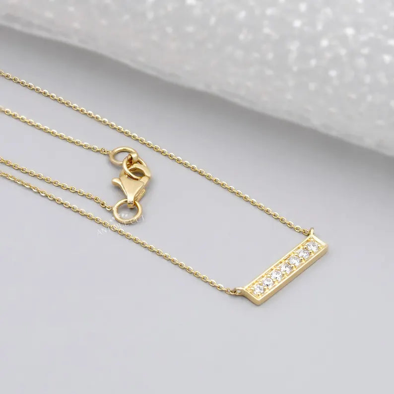 This is a detailed view of a gold chain necklace with a lobster clasp.