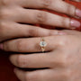 Oval solitaire engagement ring with leaf motifs