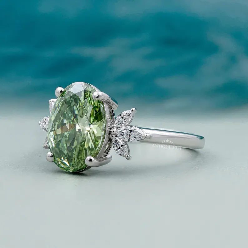 Oval green diamond ring with side stones elegant design