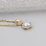 Yellow gold heart diamond necklace with round diamond halo frame