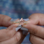 Pink pear diamond ring side view.