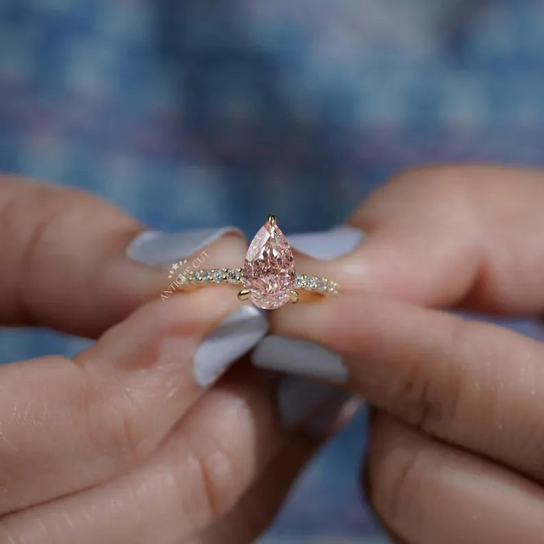 Pink pear diamond ring side view.