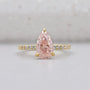 Pink diamond teardrop ring in yellow gold.