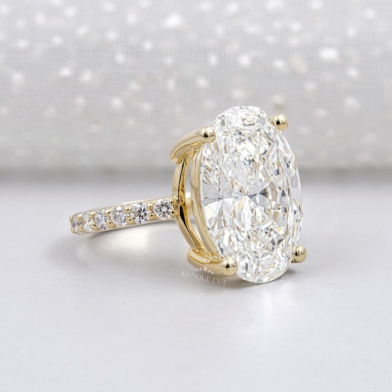 Yellow gold oval engagement ring with pavé diamond band