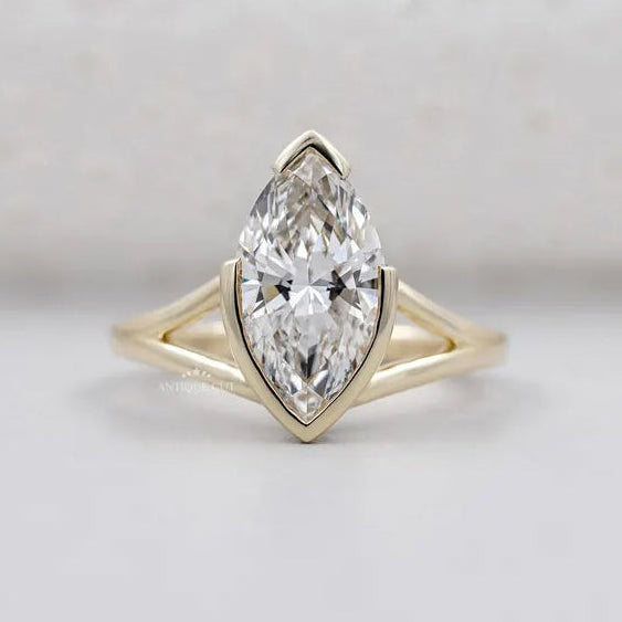 Marquise cut diamond ring with split shank in yellow gold