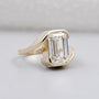 Emerald cut diamond ring in bezel setting