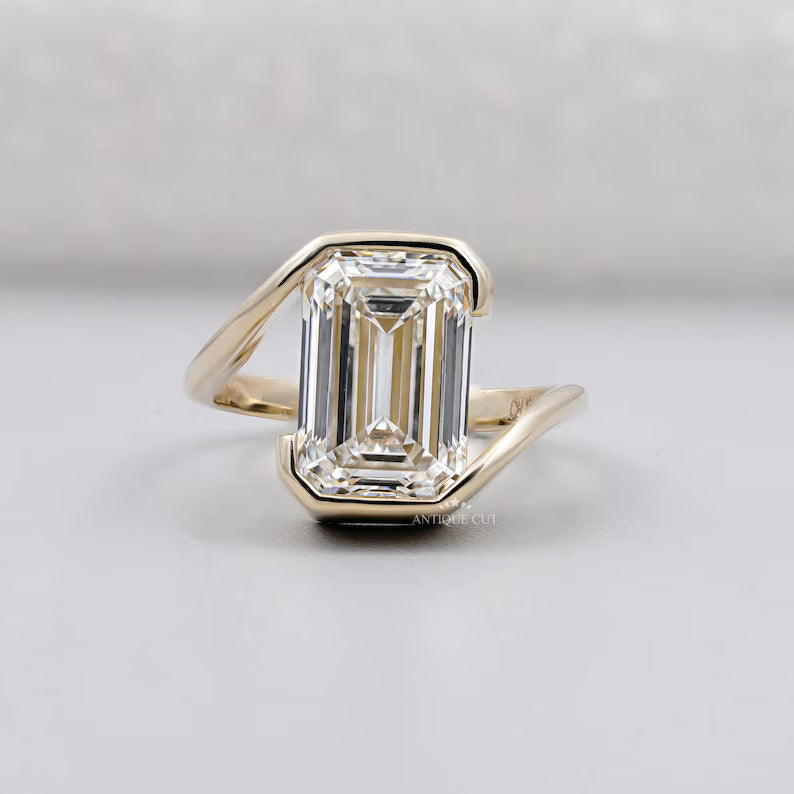Half Bezel set emerald ring with solitaire diamond