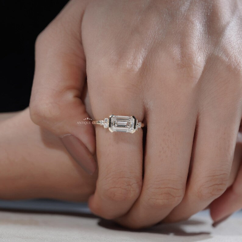 Minimal yellow gold ring with east west emerald cut diamond