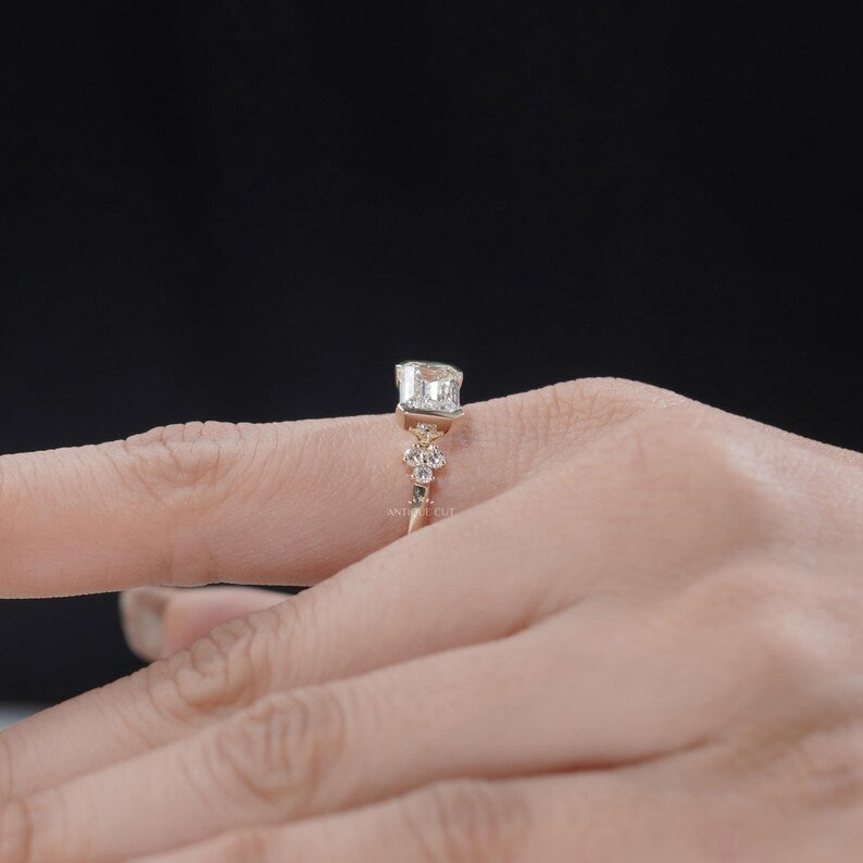 Sleek emerald cut diamond ring with half bezel setting yellow gold
