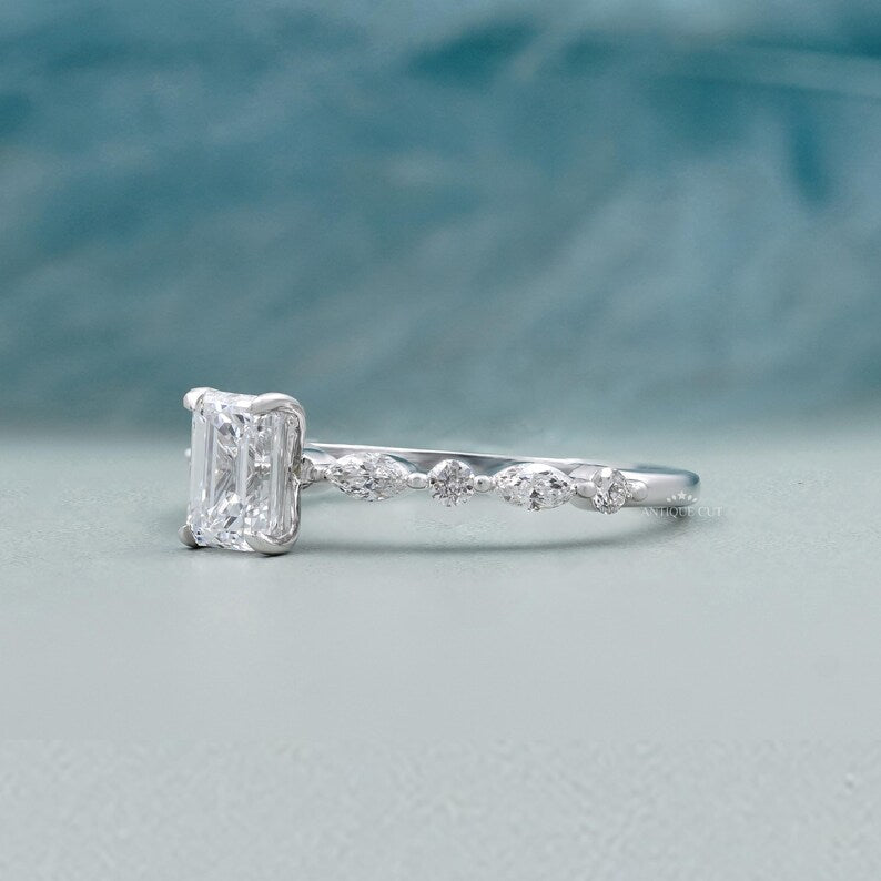 White gold emerald cut diamond ring with pave halo engagement