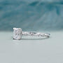 White gold emerald cut diamond ring with pave halo engagement