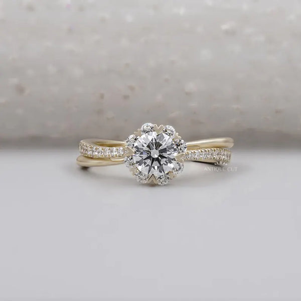 Round cut floral halo engagement ring with twisted band for buyers who want a detailed Charli XCX inspired look
