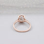 Elegant oval diamond ring with pave diamonds in rose gold