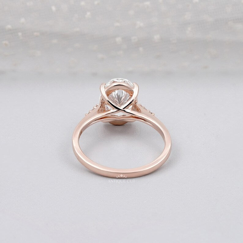 Elegant oval diamond ring with pave diamonds in rose gold