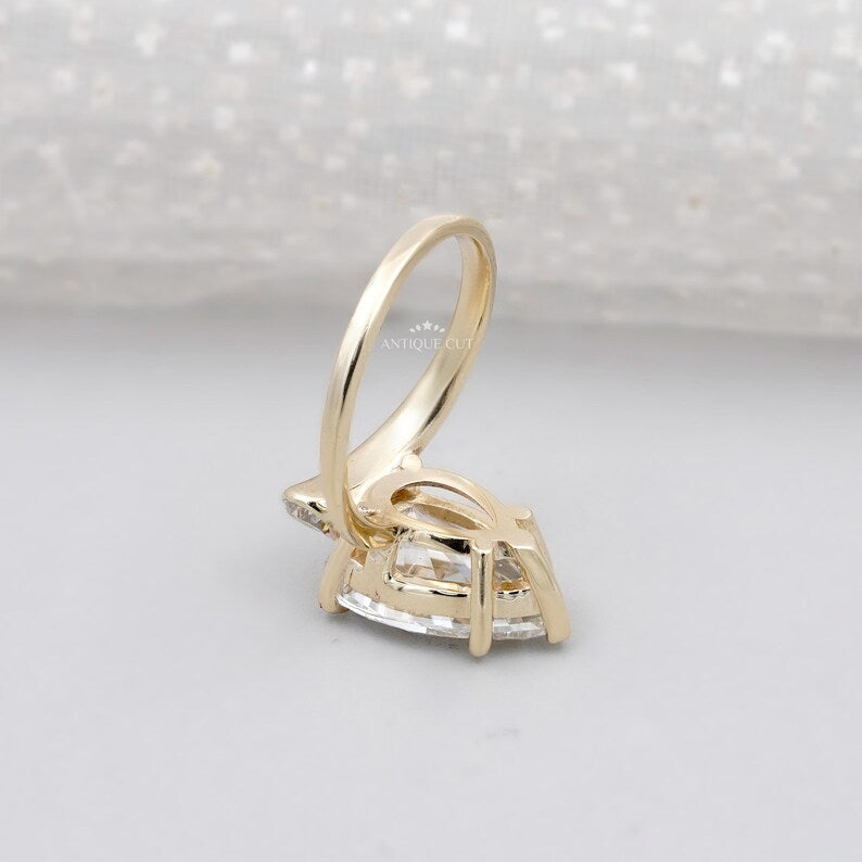 Luxury pear cut engagement ring with side diamonds yellow gold
