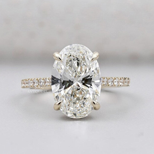 Hidden halo oval engagement ring yellow gold pave diamond band